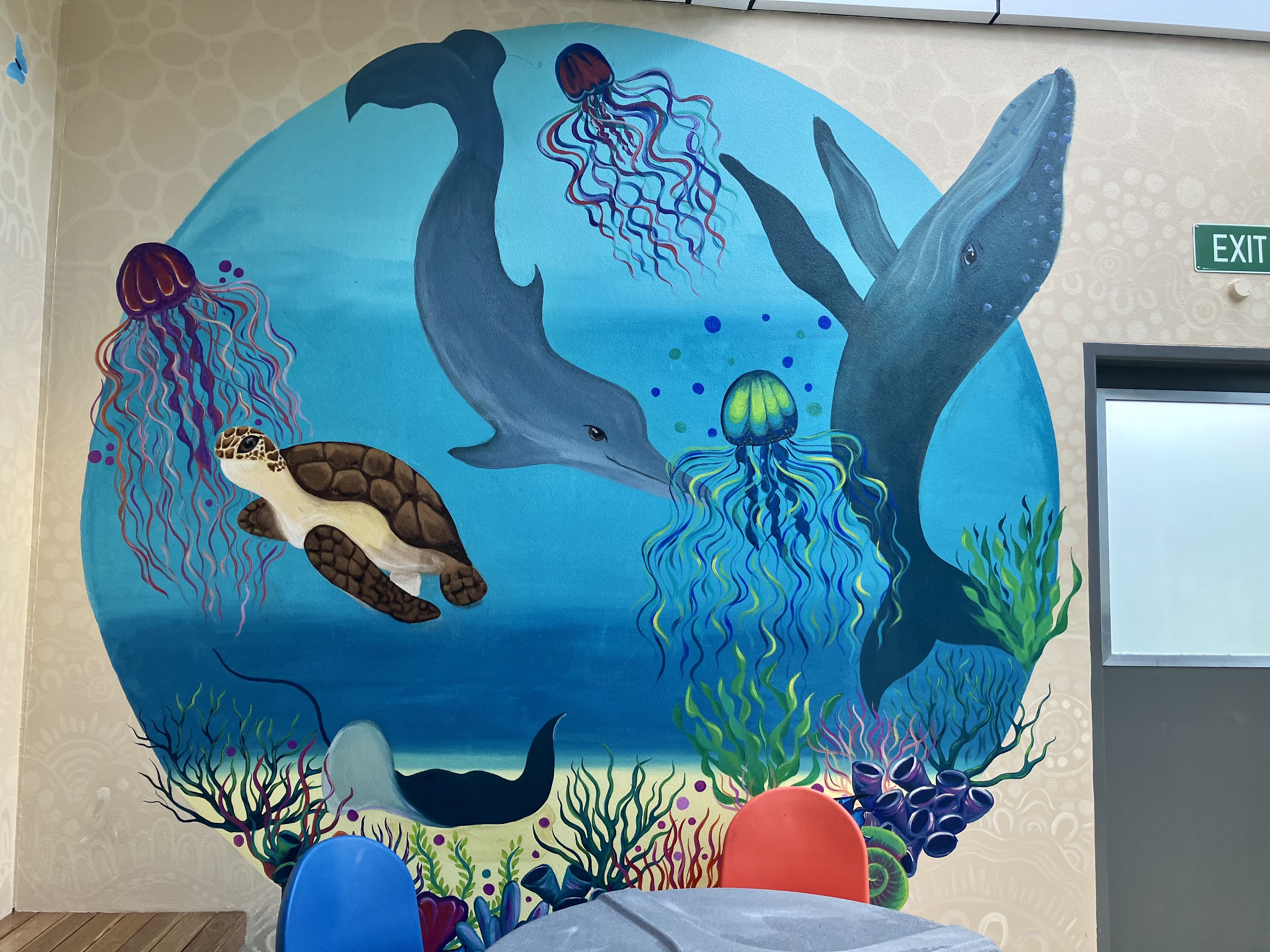 Ocean-themed mural featuring a whale and a dolphin.