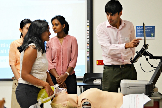 Medical interns practice on dummy