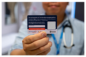 Man holds rheumatology service access card up to camera.