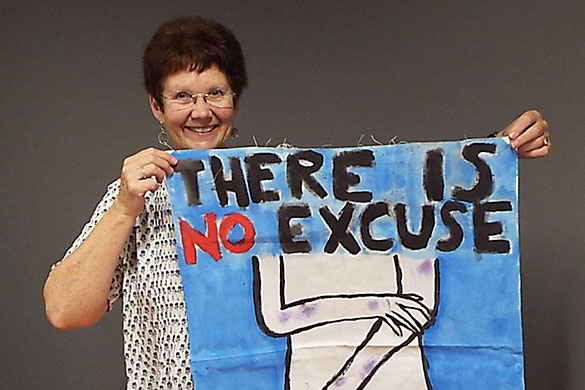 Jackie Atkinson with a poster created by students at a Love Bites program.